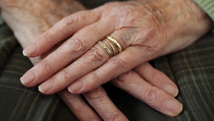Una anciana, con varios anillos de oro.