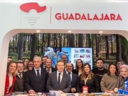 La amplia representación de cargos del PSOE en el Día de Guadalajara en Fitur, apiñada para la foto con el presidente regional.