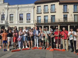 El PSOE y vecinos de algunos barrios de Guadalajara protestan, escoba en mano y durante unos minutos, en la Plaza Mayor, por la falta de limpieza de la ciudad.
