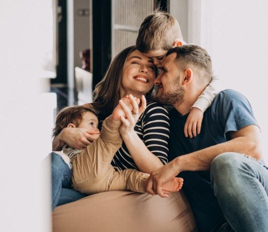 Young family with their sons at home having fun