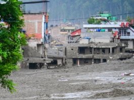NUWAKOT, NEPAL - AUGUST 26: An aftermath view of flash floods and mudslides along the Trishuli River in Nuwakot, Nepal, on August 26, 2026. A catastrophic flash flood swept through Nepal’s northern border region after an ice-and-rock avalanche, reportedly triggered by an earthquake, caused a sudden surge in the Lhende River on the Nepal-China border and sent massive volumes of water, mud and debris downstream into the Bhote Koshi and Trishuli river systems. The disaster devastated settlements in Rasuwa and Nuwakot districts, sweeping away homes, roads, bridges, vehicles and other infrastructure and severely damaging hydropower and power facilities. In Nuwakot, riverside settlements including Trishuli Bazaar, Devighat, Betrawati and surrounding areas suffered extensive destruction, with homes swept away and large quantities of mud and debris deposited across communities. The flood also disrupted communications and transportation routes and prompted authorities to evacuate vulnerable riverside communities and issue warnings along the Bhote Koshi, Trishuli and Narayani rivers. The death toll from the disaster had climbed to 97, while at least 384 tourists and travelers, including foreign nationals, as well as soldiers and police personnel, were reported missing as search-and-rescue operations continued. Nepal Army, Armed Police Force and Nepal Police personnel were deployed to affected areas, while rescue operations were also underway on the Chinese side of the border. Authorities continued to assess the scale of casualties and destruction as access to several affected areas remained difficult because of damaged roads, bridges, heavy sediment and continuing flood risks. The disaster has been described as one of the most severe sudden flood events to strike the Nepal-China border region in recent years.