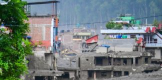 NUWAKOT, NEPAL - AUGUST 26: An aftermath view of flash floods and mudslides along the Trishuli River in Nuwakot, Nepal, on August 26, 2026. A catastrophic flash flood swept through Nepal’s northern border region after an ice-and-rock avalanche, reportedly triggered by an earthquake, caused a sudden surge in the Lhende River on the Nepal-China border and sent massive volumes of water, mud and debris downstream into the Bhote Koshi and Trishuli river systems. The disaster devastated settlements in Rasuwa and Nuwakot districts, sweeping away homes, roads, bridges, vehicles and other infrastructure and severely damaging hydropower and power facilities. In Nuwakot, riverside settlements including Trishuli Bazaar, Devighat, Betrawati and surrounding areas suffered extensive destruction, with homes swept away and large quantities of mud and debris deposited across communities. The flood also disrupted communications and transportation routes and prompted authorities to evacuate vulnerable riverside communities and issue warnings along the Bhote Koshi, Trishuli and Narayani rivers. The death toll from the disaster had climbed to 97, while at least 384 tourists and travelers, including foreign nationals, as well as soldiers and police personnel, were reported missing as search-and-rescue operations continued. Nepal Army, Armed Police Force and Nepal Police personnel were deployed to affected areas, while rescue operations were also underway on the Chinese side of the border. Authorities continued to assess the scale of casualties and destruction as access to several affected areas remained difficult because of damaged roads, bridges, heavy sediment and continuing flood risks. The disaster has been described as one of the most severe sudden flood events to strike the Nepal-China border region in recent years.