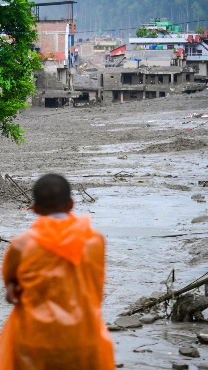 NUWAKOT, NEPAL - AUGUST 26: An aftermath view of flash floods and mudslides along the Trishuli River in Nuwakot, Nepal, on August 26, 2026. A catastrophic flash flood swept through Nepal’s northern border region after an ice-and-rock avalanche, reportedly triggered by an earthquake, caused a sudden surge in the Lhende River on the Nepal-China border and sent massive volumes of water, mud and debris downstream into the Bhote Koshi and Trishuli river systems. The disaster devastated settlements in Rasuwa and Nuwakot districts, sweeping away homes, roads, bridges, vehicles and other infrastructure and severely damaging hydropower and power facilities. In Nuwakot, riverside settlements including Trishuli Bazaar, Devighat, Betrawati and surrounding areas suffered extensive destruction, with homes swept away and large quantities of mud and debris deposited across communities. The flood also disrupted communications and transportation routes and prompted authorities to evacuate vulnerable riverside communities and issue warnings along the Bhote Koshi, Trishuli and Narayani rivers. The death toll from the disaster had climbed to 97, while at least 384 tourists and travelers, including foreign nationals, as well as soldiers and police personnel, were reported missing as search-and-rescue operations continued. Nepal Army, Armed Police Force and Nepal Police personnel were deployed to affected areas, while rescue operations were also underway on the Chinese side of the border. Authorities continued to assess the scale of casualties and destruction as access to several affected areas remained difficult because of damaged roads, bridges, heavy sediment and continuing flood risks. The disaster has been described as one of the most severe sudden flood events to strike the Nepal-China border region in recent years.